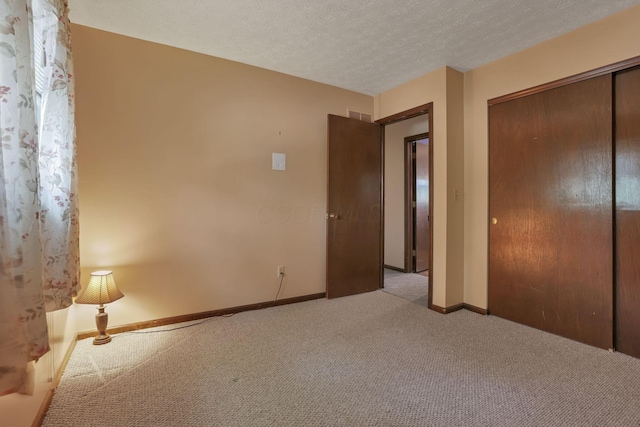 2809 Bella Via Ave, Columbus, OH 43231 - unfurnished bedroom featuring carpet, a closet, and a textured ceiling