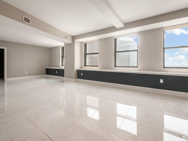 50 W Broad St Unit 2701, Columbus, OH 43215 - spare room featuring light marble finish floors and beam ceiling