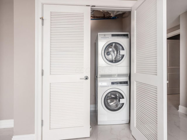 50 W Broad St Unit 2701, Columbus, OH 43215 - laundry room with stacked washer / drying machine and marble look tiles