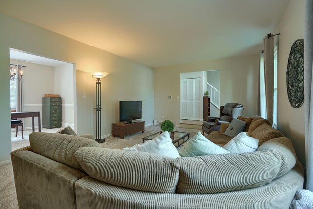 6676 Woodsedge Dr, Reynoldsburg, OH 43068 - carpeted living room featuring a chandelier and stairway