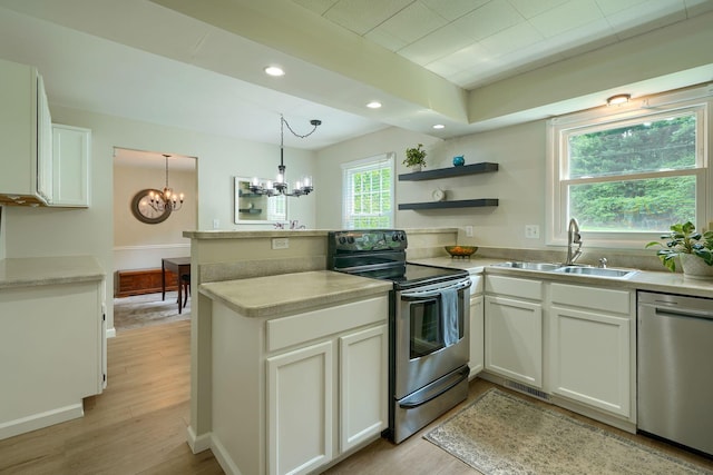 6676 Woodsedge Dr, Reynoldsburg, OH 43068 - kitchen with appliances with stainless steel finishes, a peninsula, a chandelier, white cabinets, and light wood-style flooring