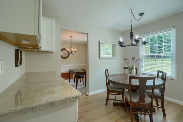 6676 Woodsedge Dr, Reynoldsburg, OH 43068 - dining area featuring a chandelier and light wood-style floors