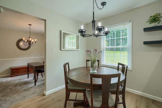 6676 Woodsedge Dr, Reynoldsburg, OH 43068 - dining room with a chandelier, healthy amount of natural light, and light wood-style floors