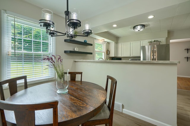 6676 Woodsedge Dr, Reynoldsburg, OH 43068 - dining space with a chandelier, wood finished floors, and recessed lighting