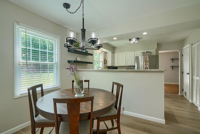 6676 Woodsedge Dr, Reynoldsburg, OH 43068 - dining area featuring light wood finished floors, a chandelier, and recessed lighting
