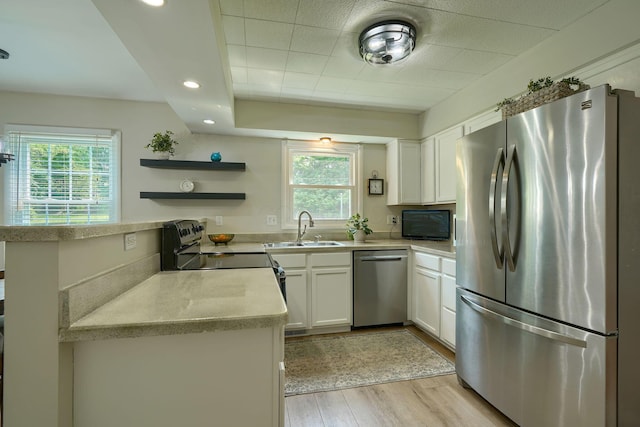 6676 Woodsedge Dr, Reynoldsburg, OH 43068 - kitchen with stainless steel appliances, light wood-style floors, white cabinetry, light countertops, and open shelves