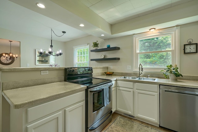6676 Woodsedge Dr, Reynoldsburg, OH 43068 - kitchen with appliances with stainless steel finishes, a chandelier, a peninsula, open shelves, and white cabinetry