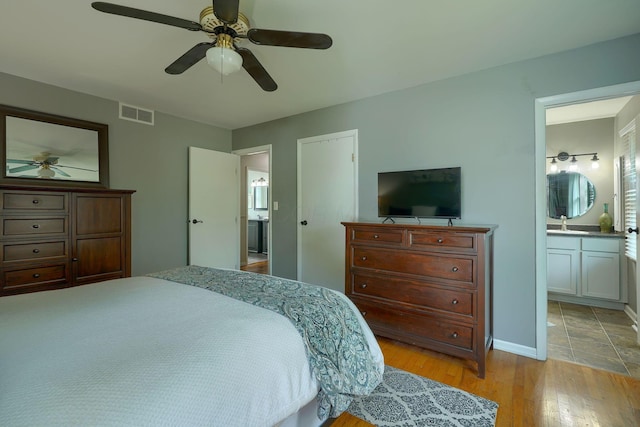 6676 Woodsedge Dr, Reynoldsburg, OH 43068 - bedroom with light wood-type flooring, ensuite bathroom, and ceiling fan