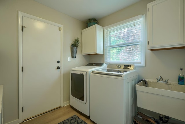 6676 Woodsedge Dr, Reynoldsburg, OH 43068 - washroom with cabinet space, independent washer and dryer, and light wood-type flooring