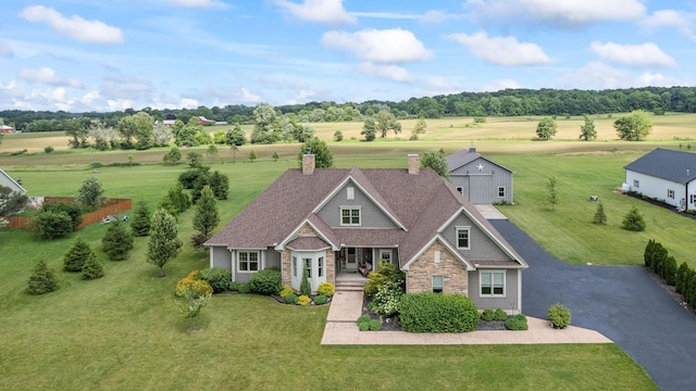 124 Dutch Ridge Way, Johnstown, OH 43031 - view of front of property with a front yard, a chimney, stone siding, and covered porch