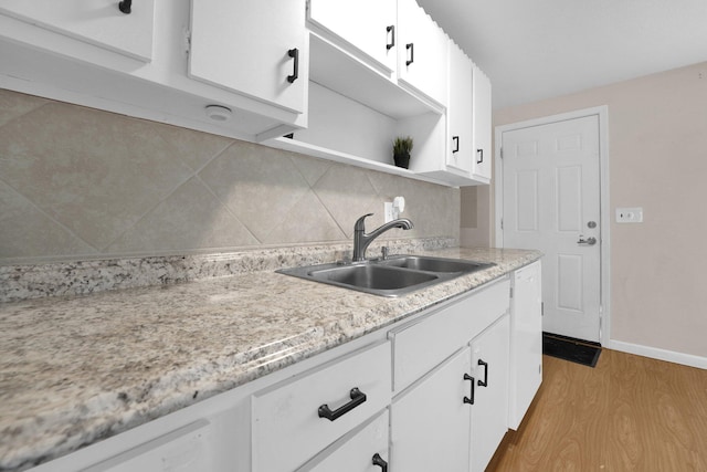 2047 Brookfield Rd, Columbus, OH 43229 - kitchen featuring open shelves, light wood-type flooring, white cabinetry, and tasteful backsplash