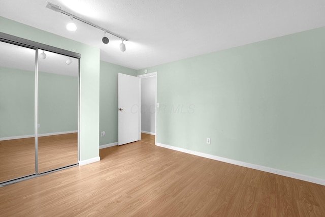 2047 Brookfield Rd, Columbus, OH 43229 - unfurnished bedroom with light wood-style floors, a closet, and rail lighting