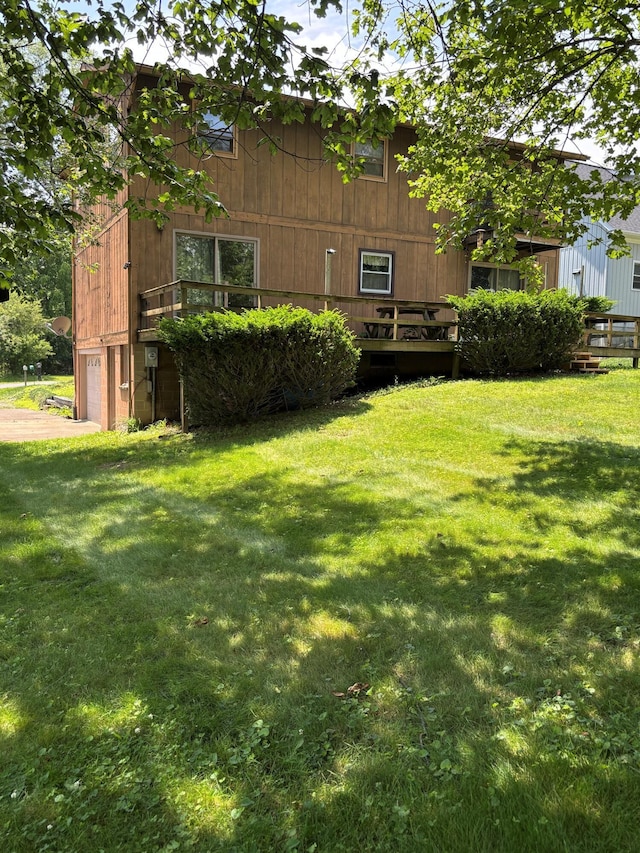 54 Appleview Ct, Howard, OH 43028 - view of green lawn featuring a garage, driveway, and a wooden deck