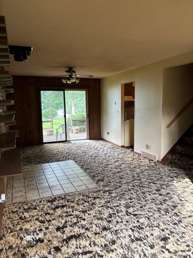 54 Appleview Ct, Howard, OH 43028 - unfurnished living room featuring a textured ceiling, stairway, and ceiling fan