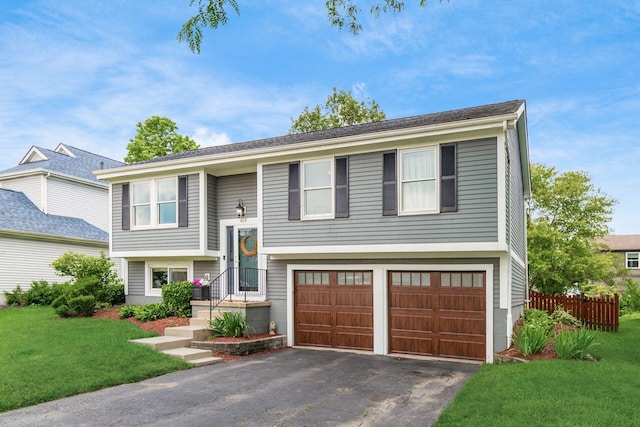 658 Academy Dr, Galloway, OH 43119 - split foyer home featuring a garage and asphalt driveway
