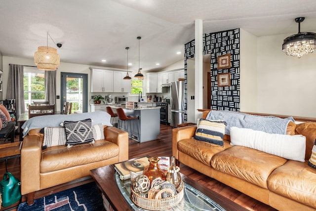 658 Academy Dr, Galloway, OH 43119 - living area featuring dark wood finished floors, lofted ceiling, healthy amount of natural light, a chandelier, and recessed lighting