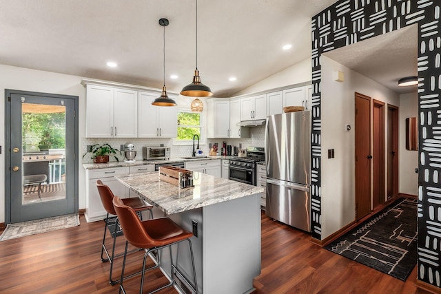 658 Academy Dr, Galloway, OH 43119 - kitchen featuring appliances with stainless steel finishes, tasteful backsplash, a kitchen island, dark wood-type flooring, and recessed lighting