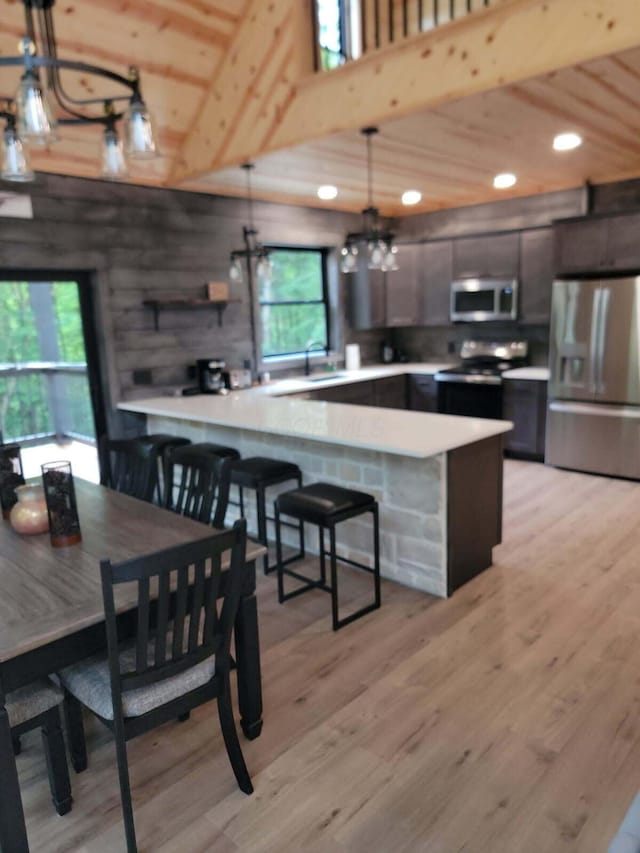 18358 Buckingham Rd, Logan, OH 43138 - kitchen featuring stainless steel fridge, black range with electric cooktop, wood ceiling, healthy amount of natural light, and light countertops