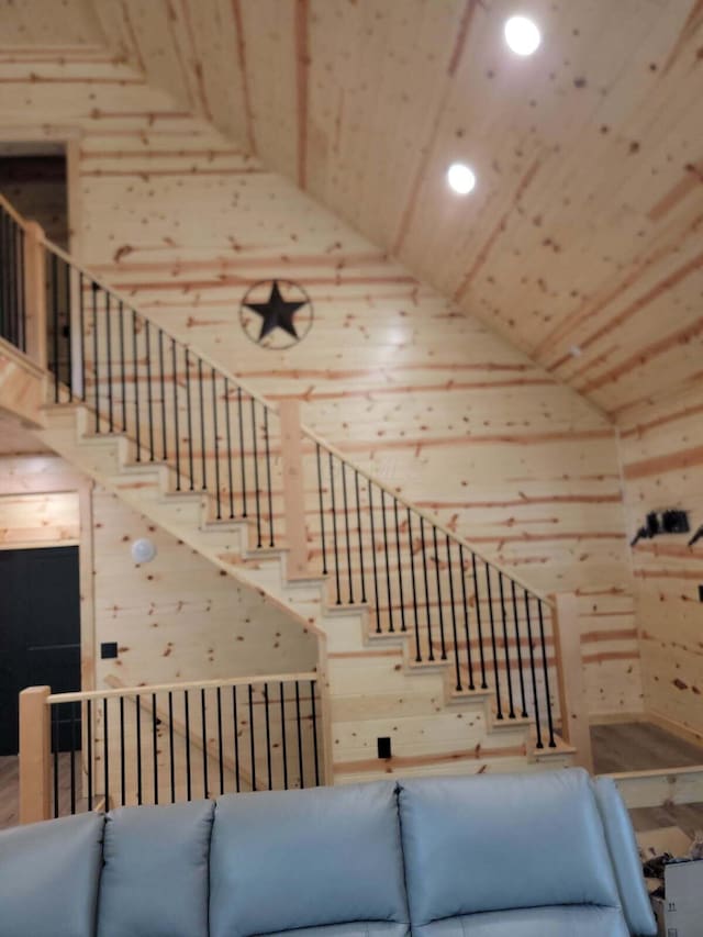 18358 Buckingham Rd, Logan, OH 43138 - unfurnished living room featuring high vaulted ceiling, stairway, wood walls, and recessed lighting