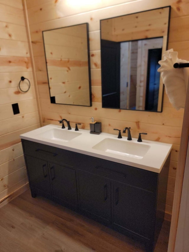 18358 Buckingham Rd, Logan, OH 43138 - bathroom featuring double vanity, wooden walls, and wood finished floors