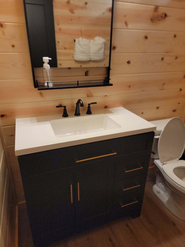 18358 Buckingham Rd, Logan, OH 43138 - half bathroom with vanity, wood finished floors, and wooden walls