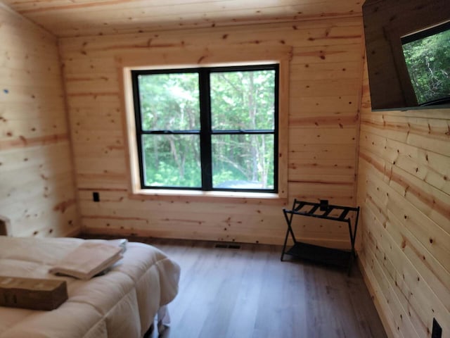 18358 Buckingham Rd, Logan, OH 43138 - bedroom featuring wood walls, multiple windows, and wood finished floors