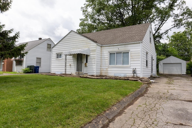 139 S Ashburton Rd, Columbus, OH 43213 - view of front of house with roof with shingles, an outbuilding, driveway, a front lawn, and a detached garage