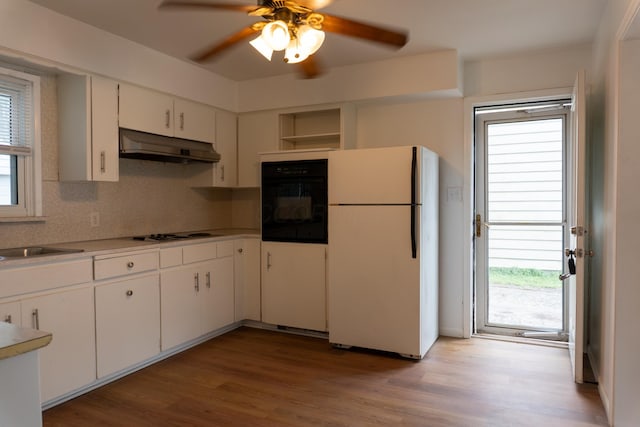139 S Ashburton Rd, Columbus, OH 43213 - kitchen with freestanding refrigerator, oven, under cabinet range hood, tasteful backsplash, and a ceiling fan