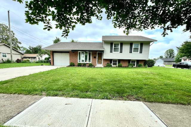 5200 Williamsburg Cir, Hilliard, OH 43026 - tri-level home with an attached garage, driveway, a front lawn, and brick siding
