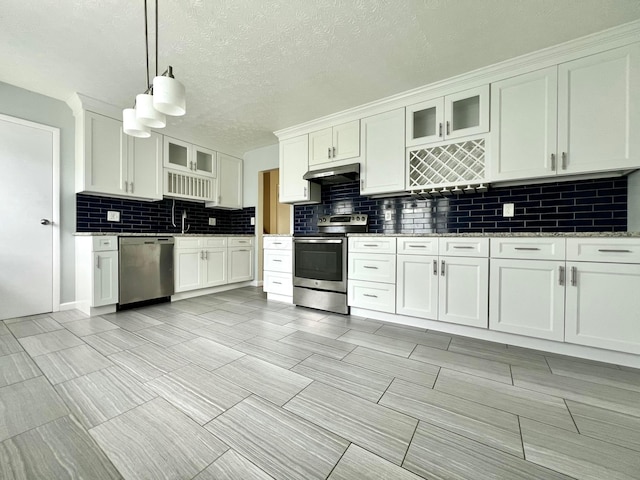 5200 Williamsburg Cir, Hilliard, OH 43026 - kitchen with appliances with stainless steel finishes, under cabinet range hood, decorative backsplash, white cabinetry, and glass insert cabinets