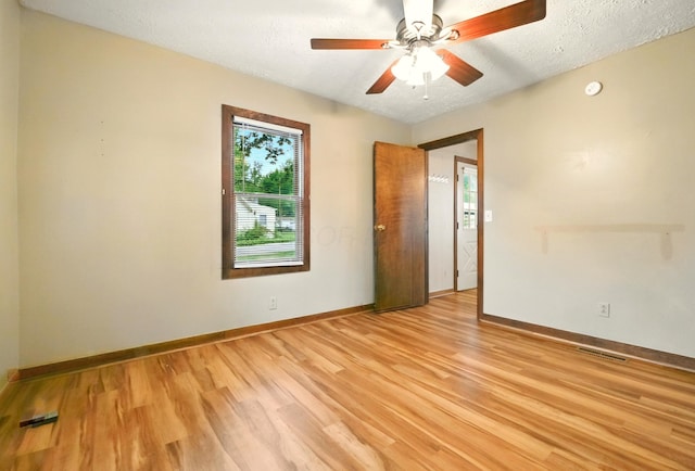 3001/2 Calhoun St, Mount Vernon, OH 43050 - empty room with light wood-style flooring, a ceiling fan, a textured ceiling, and a smoke detector