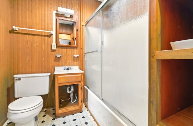 3001/2 Calhoun St, Mount Vernon, OH 43050 - bathroom with tile patterned floors, wood walls, vanity, and bath / shower combo with glass door