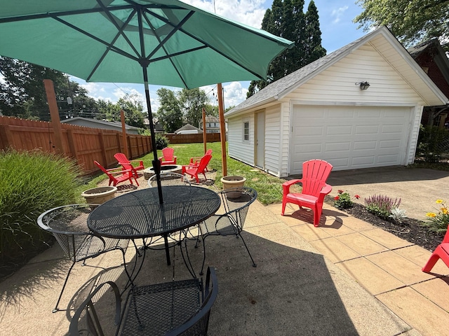 552 E 5th Ave, Lancaster, OH 43130 - view of patio / terrace with an outdoor fire pit, an outbuilding, a detached garage, and concrete driveway
