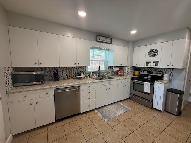 552 E 5th Ave, Lancaster, OH 43130 - kitchen with appliances with stainless steel finishes, tasteful backsplash, light countertops, white cabinetry, and recessed lighting
