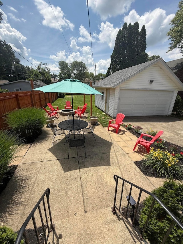 552 E 5th Ave, Lancaster, OH 43130 - view of patio with an outdoor fire pit, a detached garage, and an outbuilding