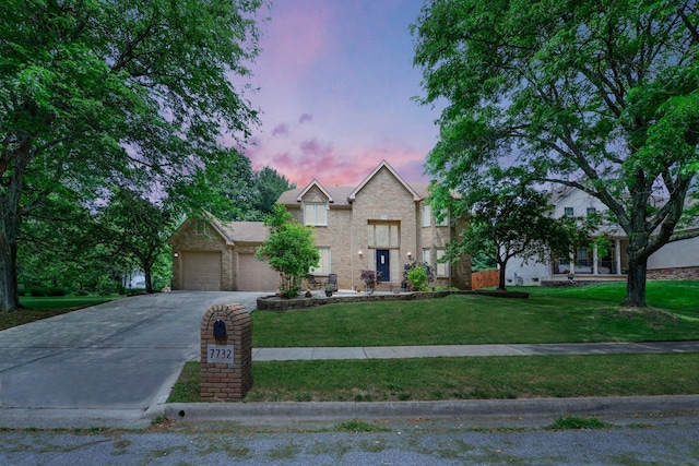 7732 Quarry Cliff Ct, Reynoldsburg, OH 43068 - traditional home with concrete driveway, a garage, a front yard, and brick siding