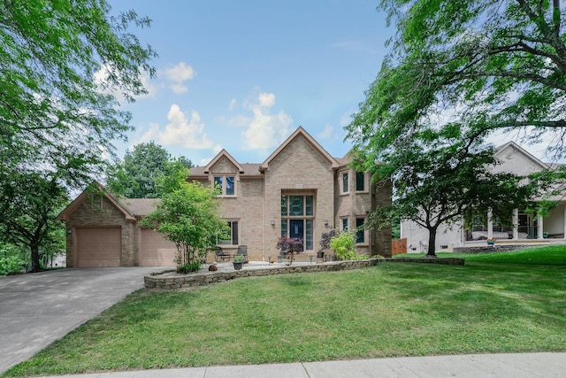 7732 Quarry Cliff Ct, Reynoldsburg, OH 43068 - traditional-style house featuring an attached garage, concrete driveway, a front lawn, and brick siding