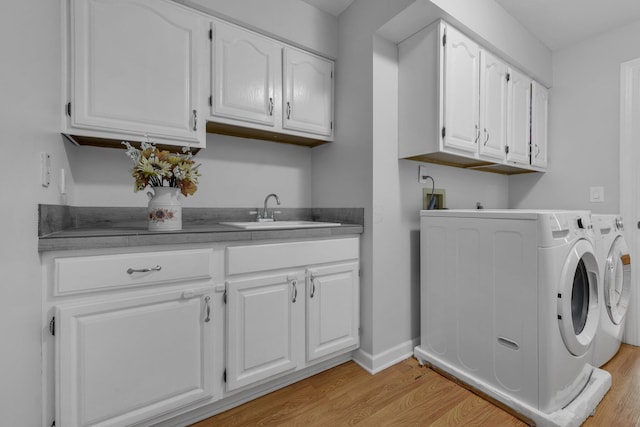 7732 Quarry Cliff Ct, Reynoldsburg, OH 43068 - washroom featuring cabinet space, light wood finished floors, and separate washer and dryer
