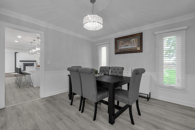 7732 Quarry Cliff Ct, Reynoldsburg, OH 43068 - dining room with a chandelier, plenty of natural light, crown molding, a wainscoted wall, and wood finished floors