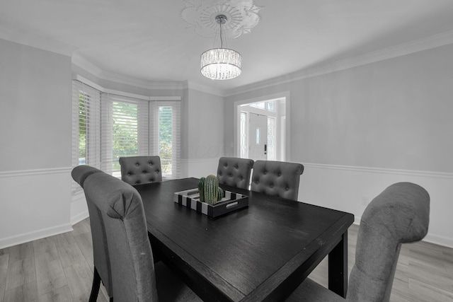 7732 Quarry Cliff Ct, Reynoldsburg, OH 43068 - dining area with a chandelier, plenty of natural light, light wood-style flooring, and ornamental molding