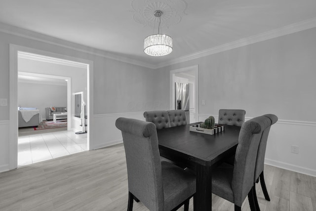 7732 Quarry Cliff Ct, Reynoldsburg, OH 43068 - dining area with a chandelier, light wood-style flooring, crown molding, and a wainscoted wall