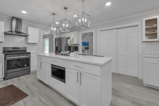 7732 Quarry Cliff Ct, Reynoldsburg, OH 43068 - kitchen featuring appliances with stainless steel finishes, wall chimney exhaust hood, backsplash, a chandelier, and ornamental molding