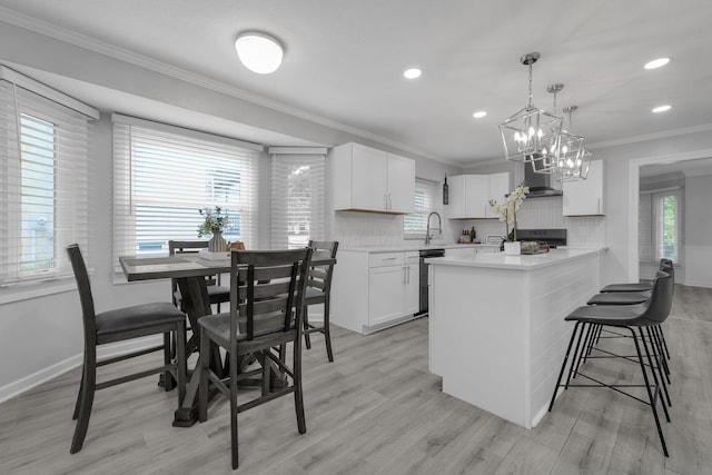 7732 Quarry Cliff Ct, Reynoldsburg, OH 43068 - kitchen with plenty of natural light, light countertops, decorative backsplash, ornamental molding, and recessed lighting