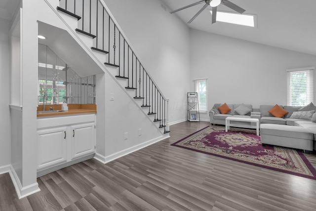 7732 Quarry Cliff Ct, Reynoldsburg, OH 43068 - living area featuring a ceiling fan, stairway, dark wood-type flooring, and high vaulted ceiling