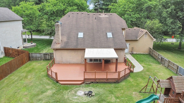 7732 Quarry Cliff Ct, Reynoldsburg, OH 43068 - back of property featuring a chimney, a deck, a fenced backyard, a playground, and roof with shingles