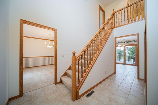 1948 Wendover Cir NE, North Canton, OH 44720 - stairway featuring a chandelier, a towering ceiling, carpet floors, and tile patterned floors