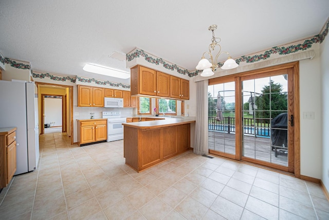 1948 Wendover Cir NE, North Canton, OH 44720 - kitchen with white appliances, a peninsula, a chandelier, light countertops, and brown cabinetry