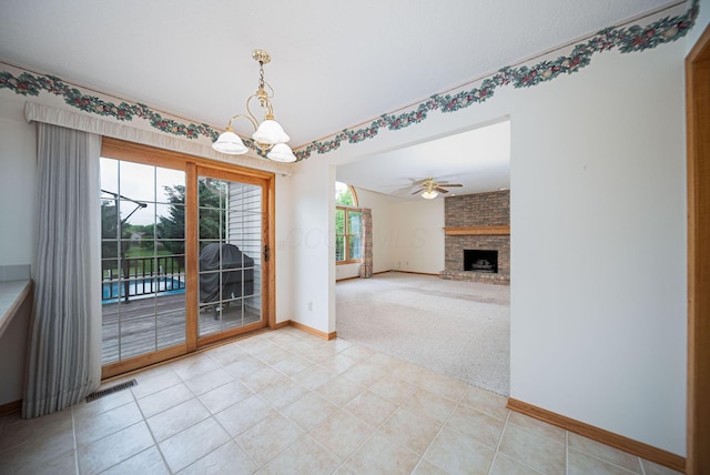 1948 Wendover Cir NE, North Canton, OH 44720 - unfurnished dining area with a chandelier, light colored carpet, a fireplace, and ceiling fan