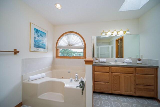 1948 Wendover Cir NE, North Canton, OH 44720 - bathroom featuring vanity, a tub with jets, a shower stall, and a skylight