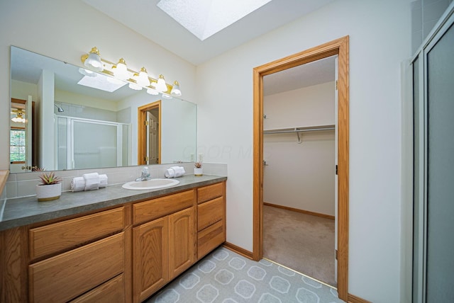 1948 Wendover Cir NE, North Canton, OH 44720 - bathroom with a skylight, a stall shower, vanity, and a walk in closet